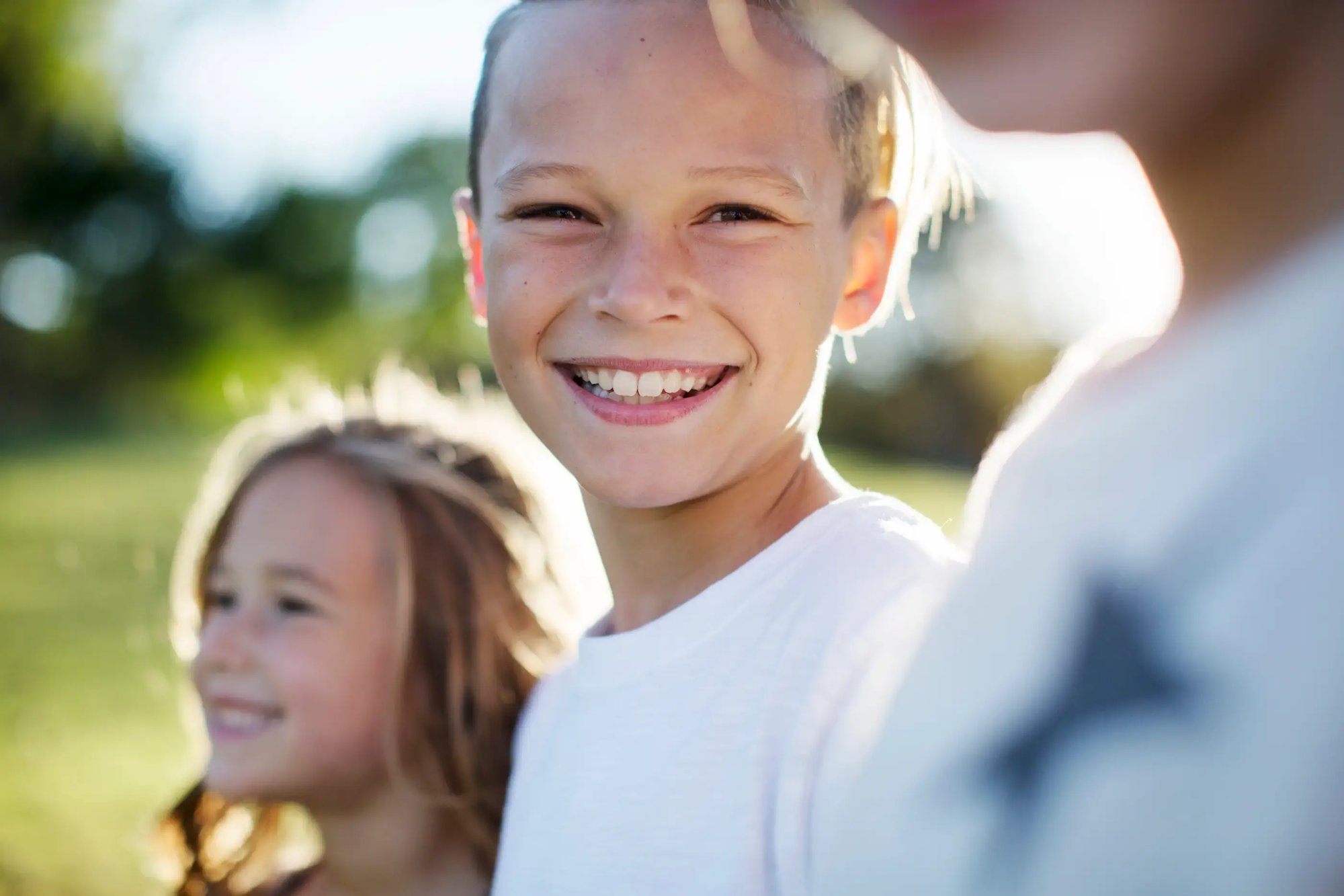cute kids smiling outside