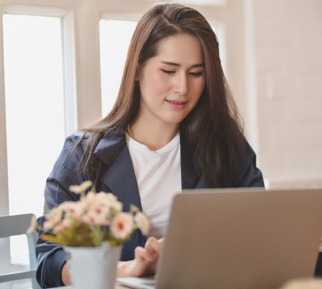 woman logging into member center on laptop